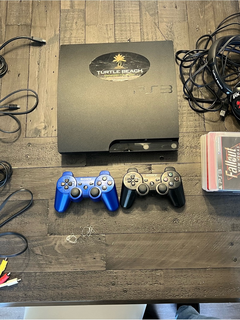 Sony PS3 Slim Console with Blue and Black DualShock Controllers